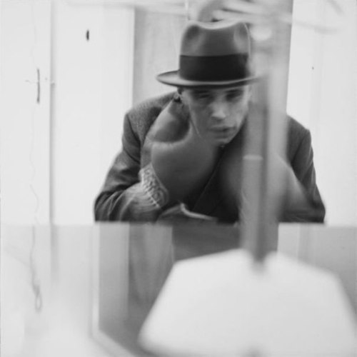 Joseph Beuys performing his piece “Felt TV” (photo by Lothar Wolleh, via Wikipedia)